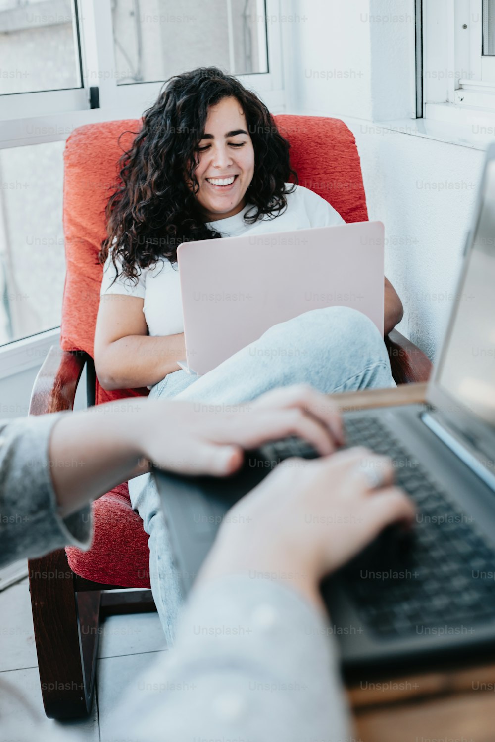a woman sitting in a chair with a laptop