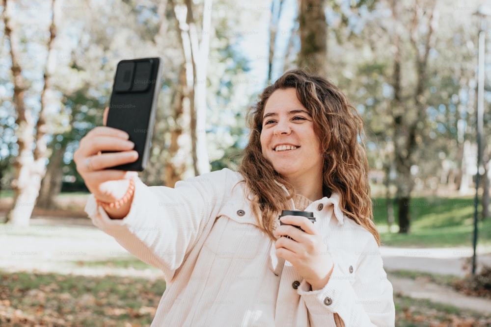 a woman taking a selfie with her cell phone