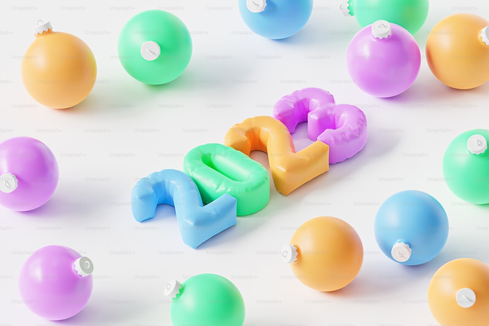 um grupo de bolas de plástico e letras em uma superfície branca