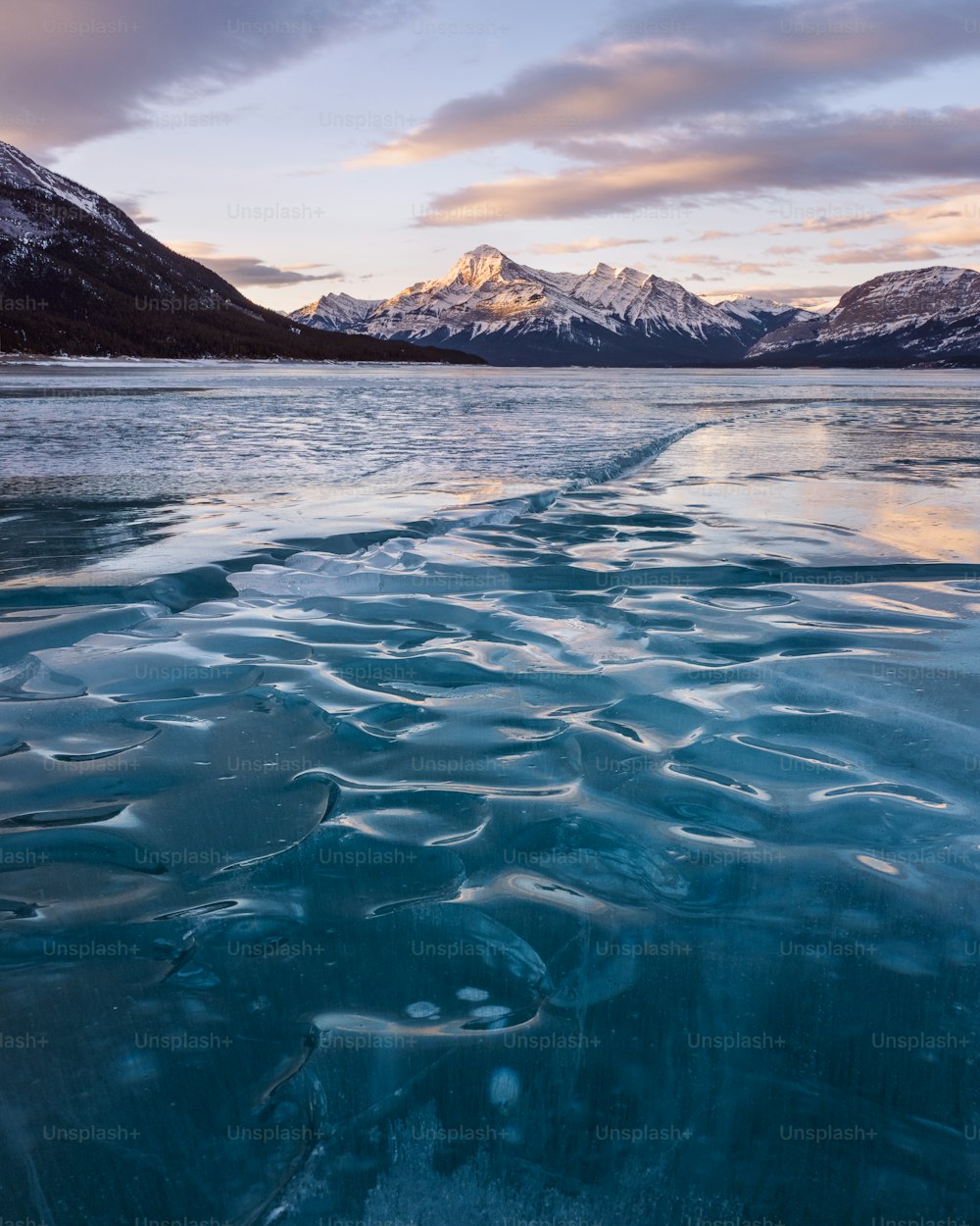 a body of water with mountains in the background