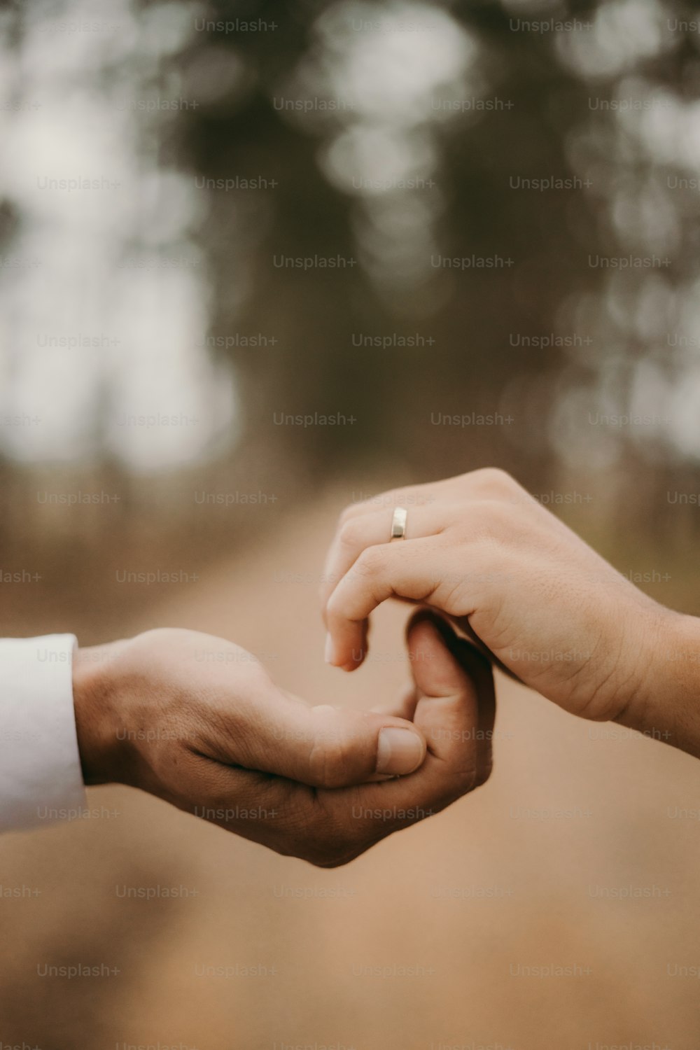 a close up of two people holding hands