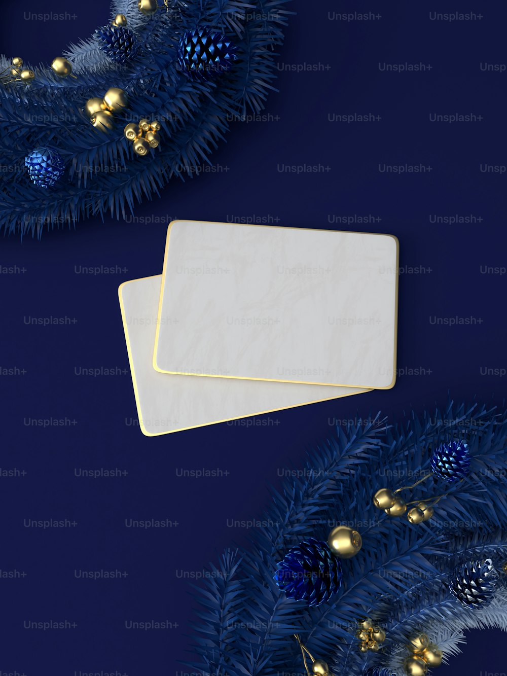 two white cards sitting on top of a blue christmas tree