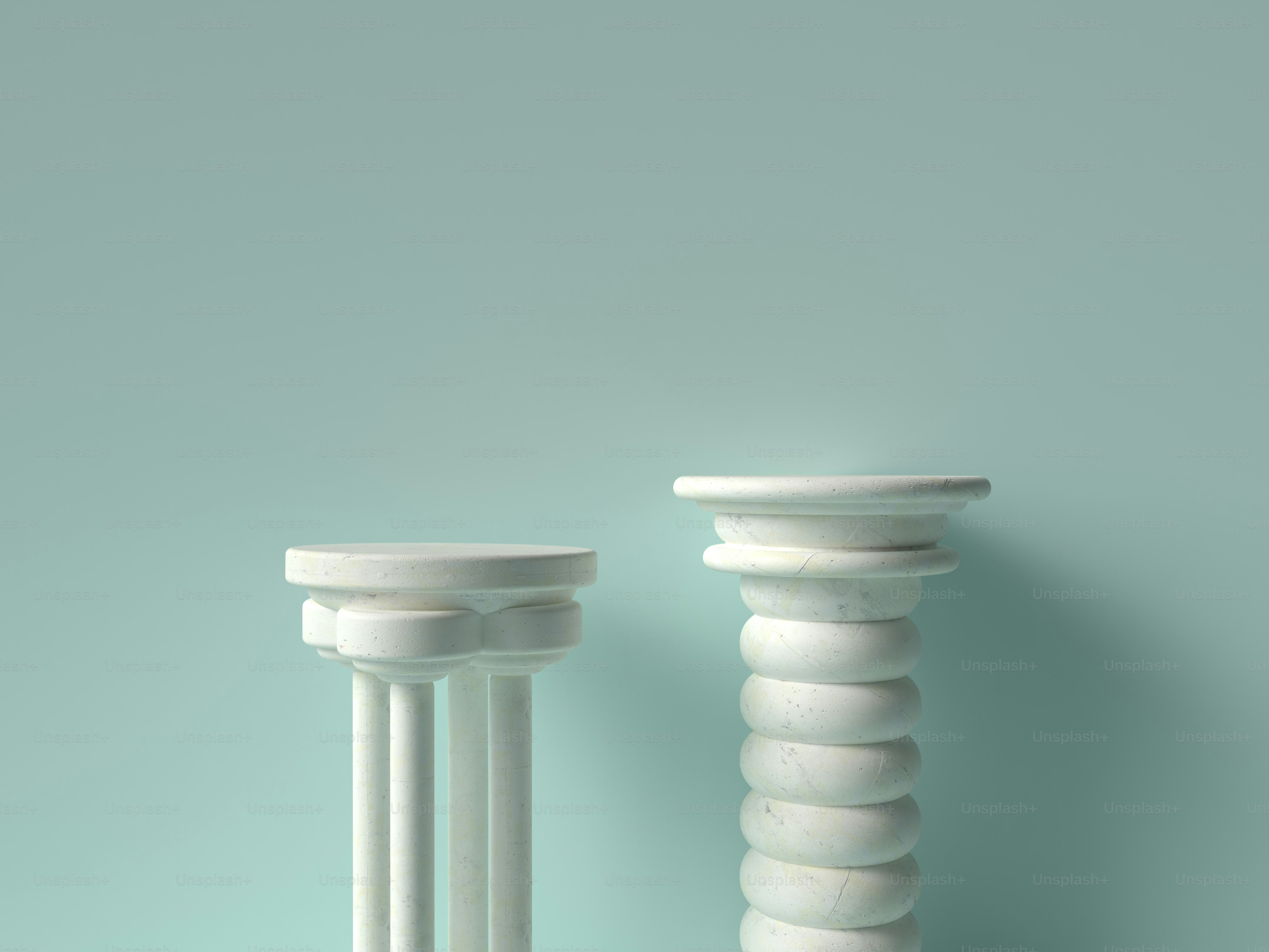 a couple of white pedestals sitting next to each other