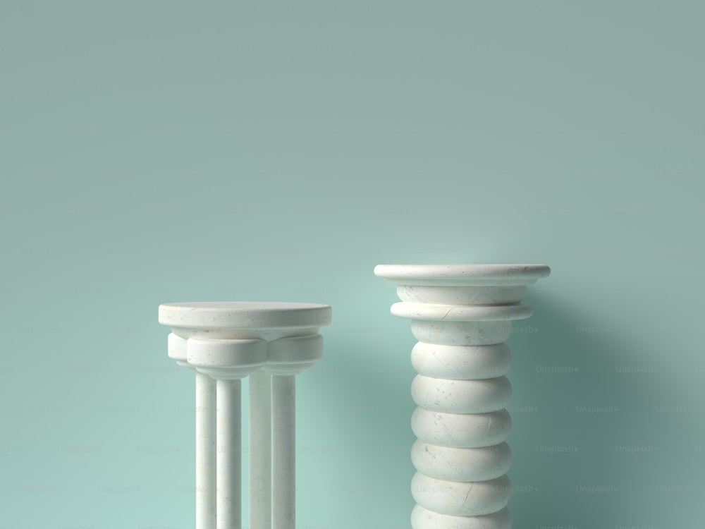 a couple of white pedestals sitting next to each other