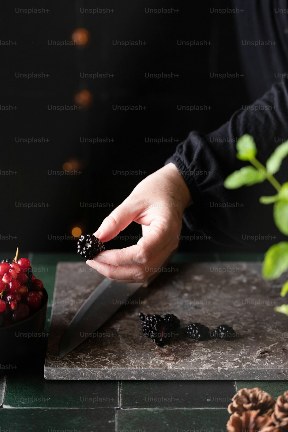 a person cutting berries on a cutting board