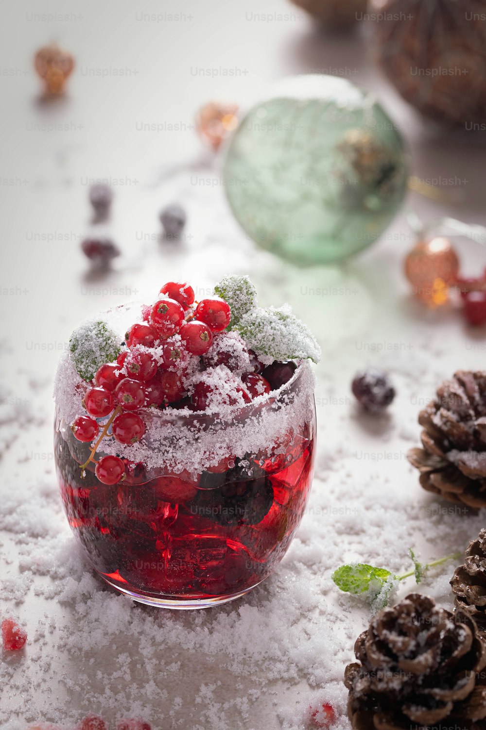 a glass bowl filled with berries and snow