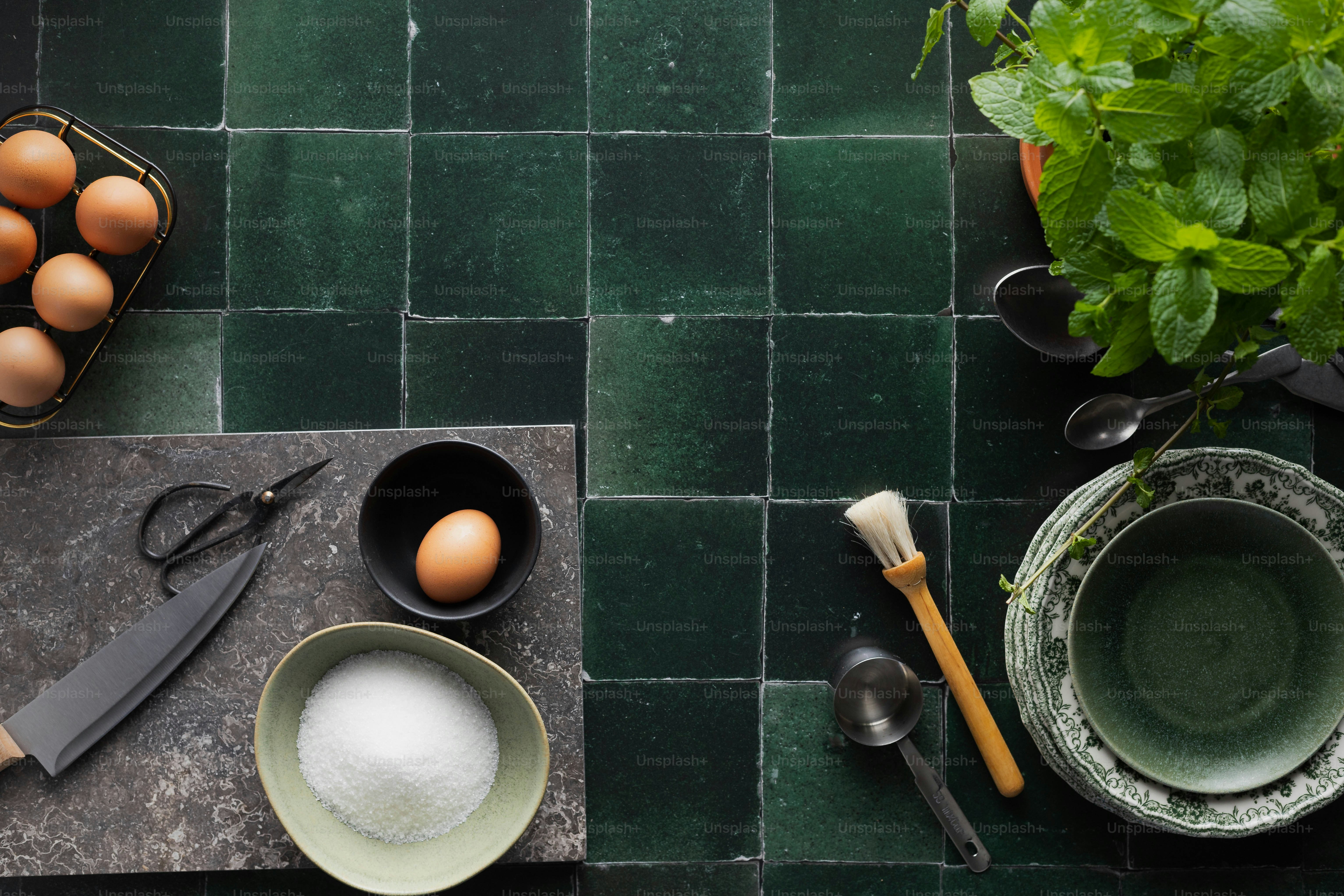 a kitchen counter with eggs and utensils on it