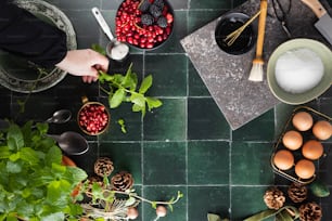 a person preparing food on a green tile floor