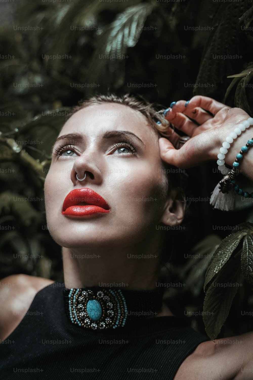 a woman with red lipstick and a necklace