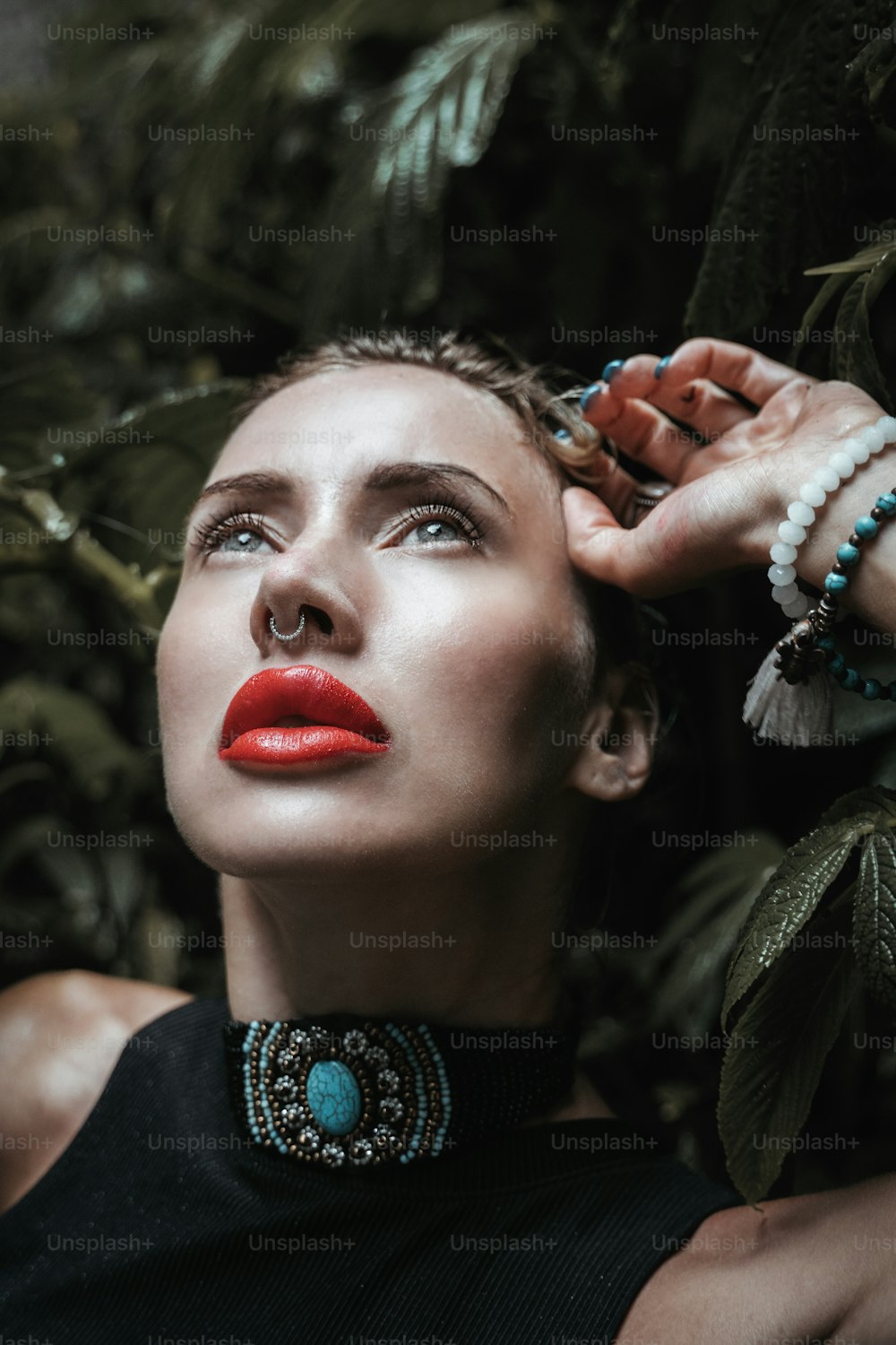 a woman with red lipstick and a necklace