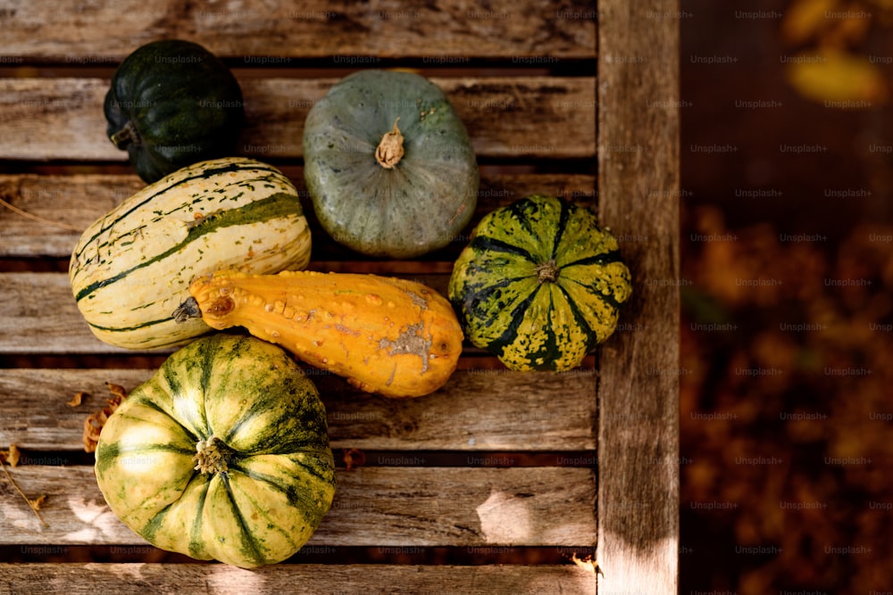 a group of squash sitting on top of a wooden table