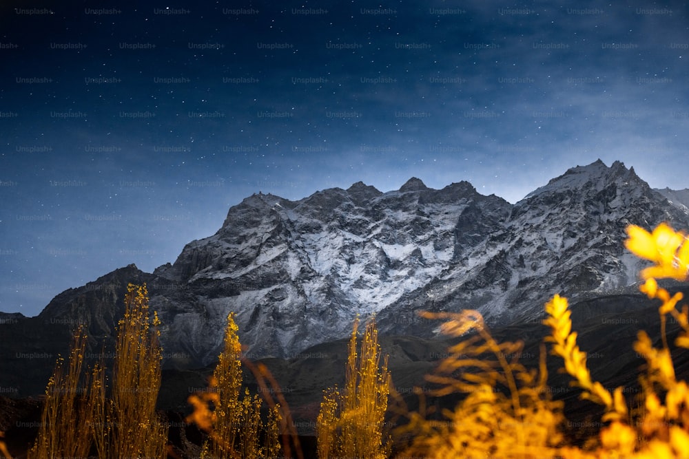 a view of a snow covered mountain at night