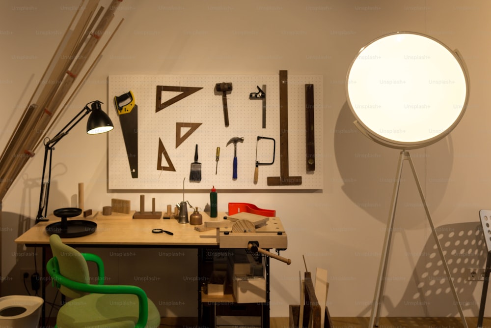 a workbench with tools and a lamp on a table