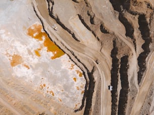 an aerial view of a dirt road and a hill