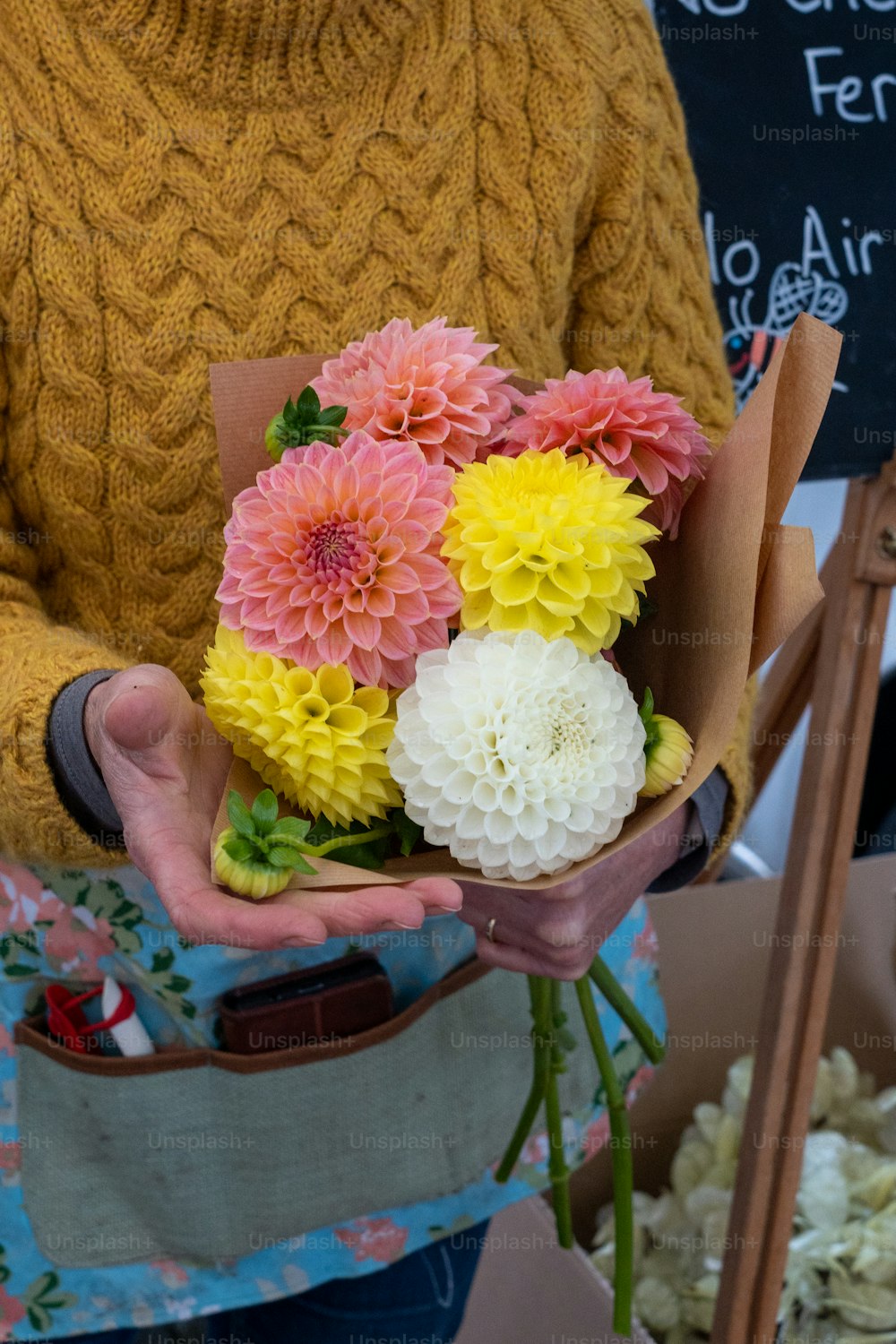 a person holding a bouquet of flowers in their hands