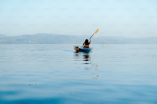 a person in a kayak paddling on the water