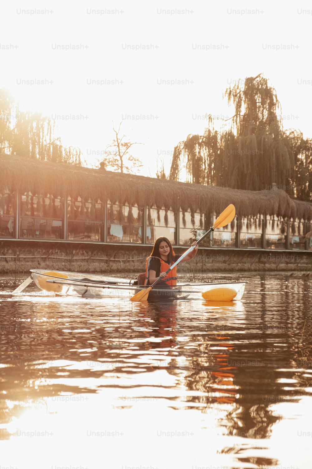 a woman in a kayak paddling down a river