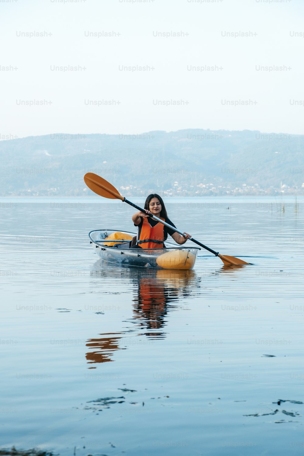 a woman in a kayak paddling on the water