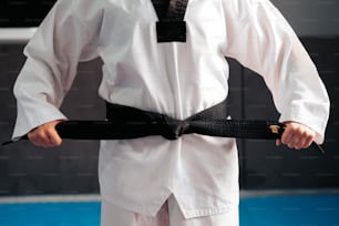 a man holding a black belt in his hand
