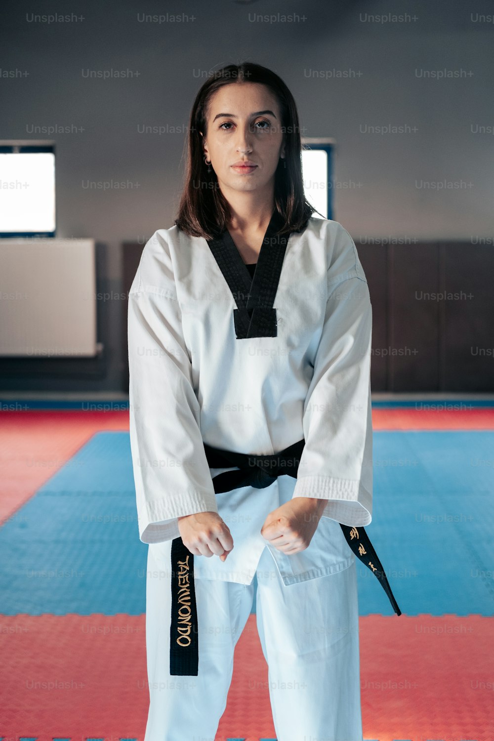 a woman in a karate outfit posing for a picture