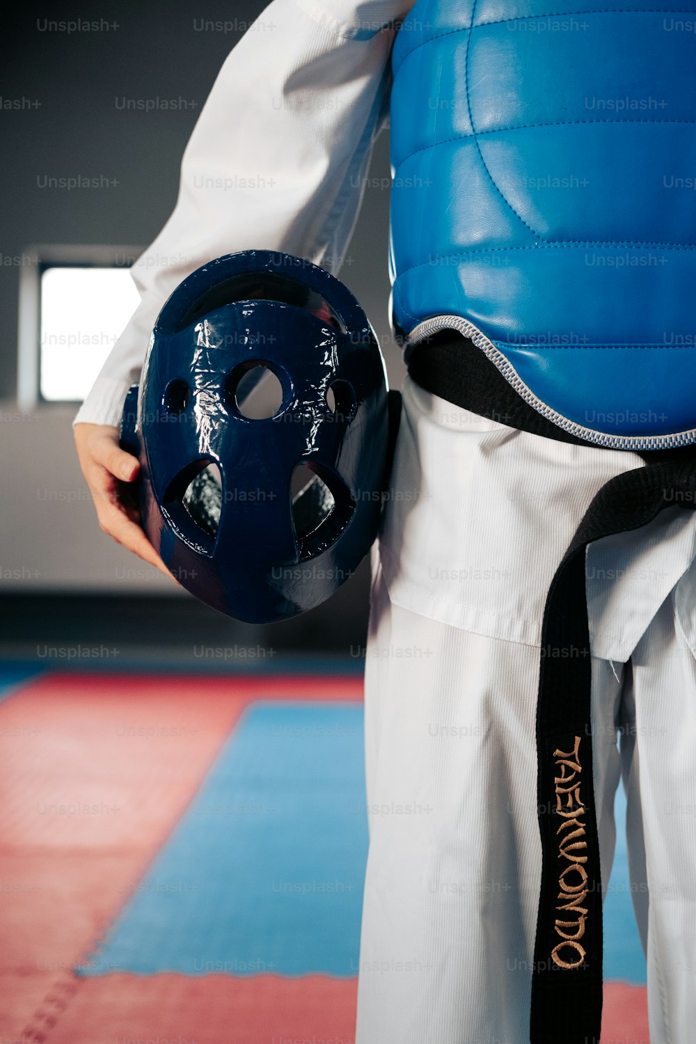 a person wearing a blue helmet and black belt