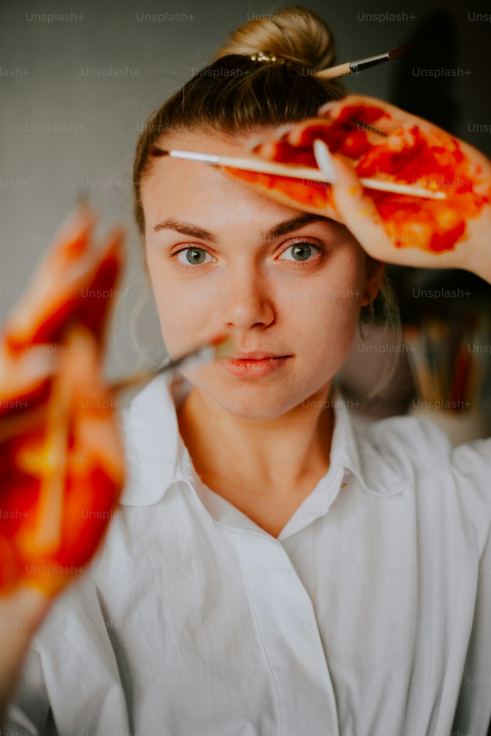 a woman holding a pizza in her hands