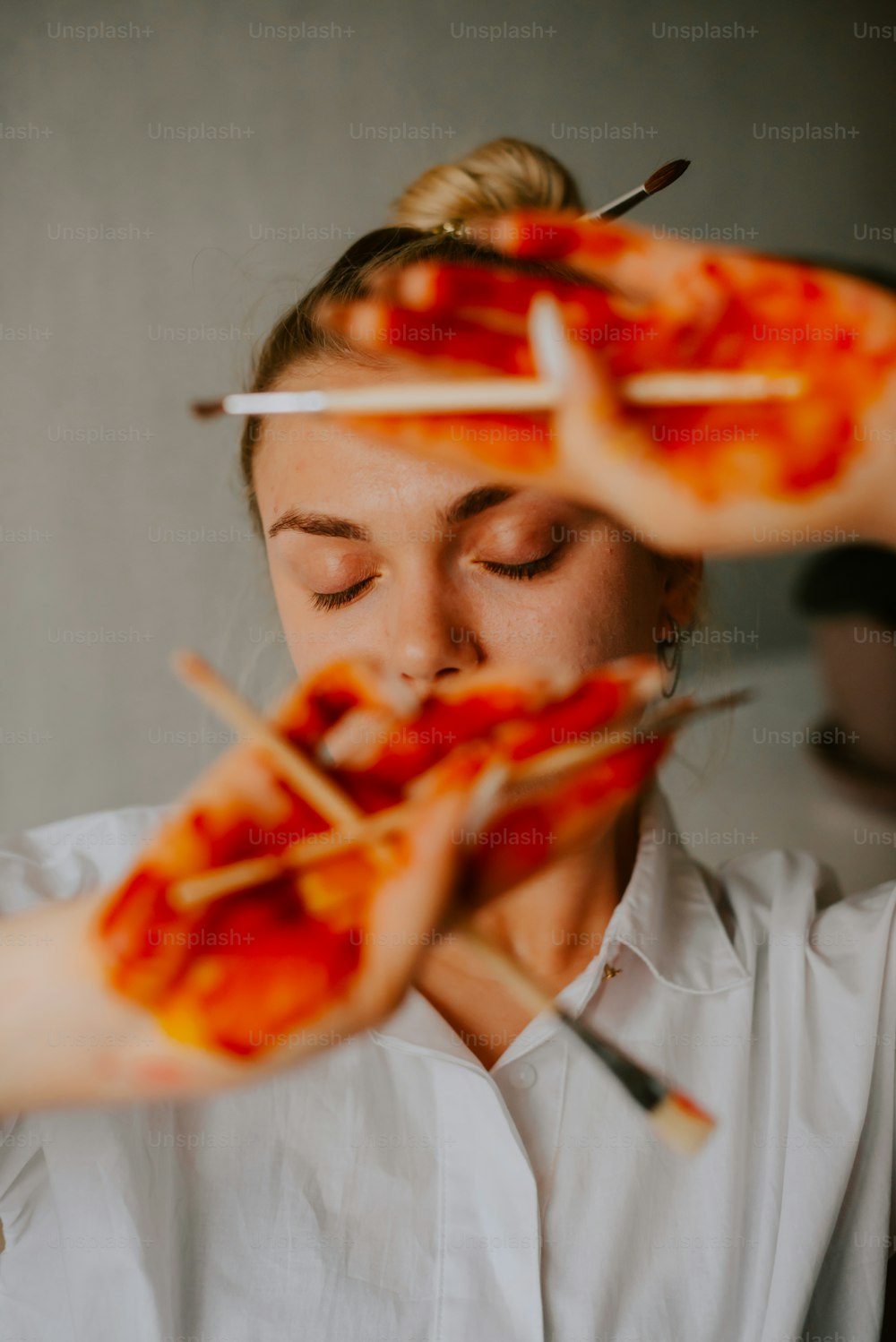a woman holding a pizza on a stick in her hands