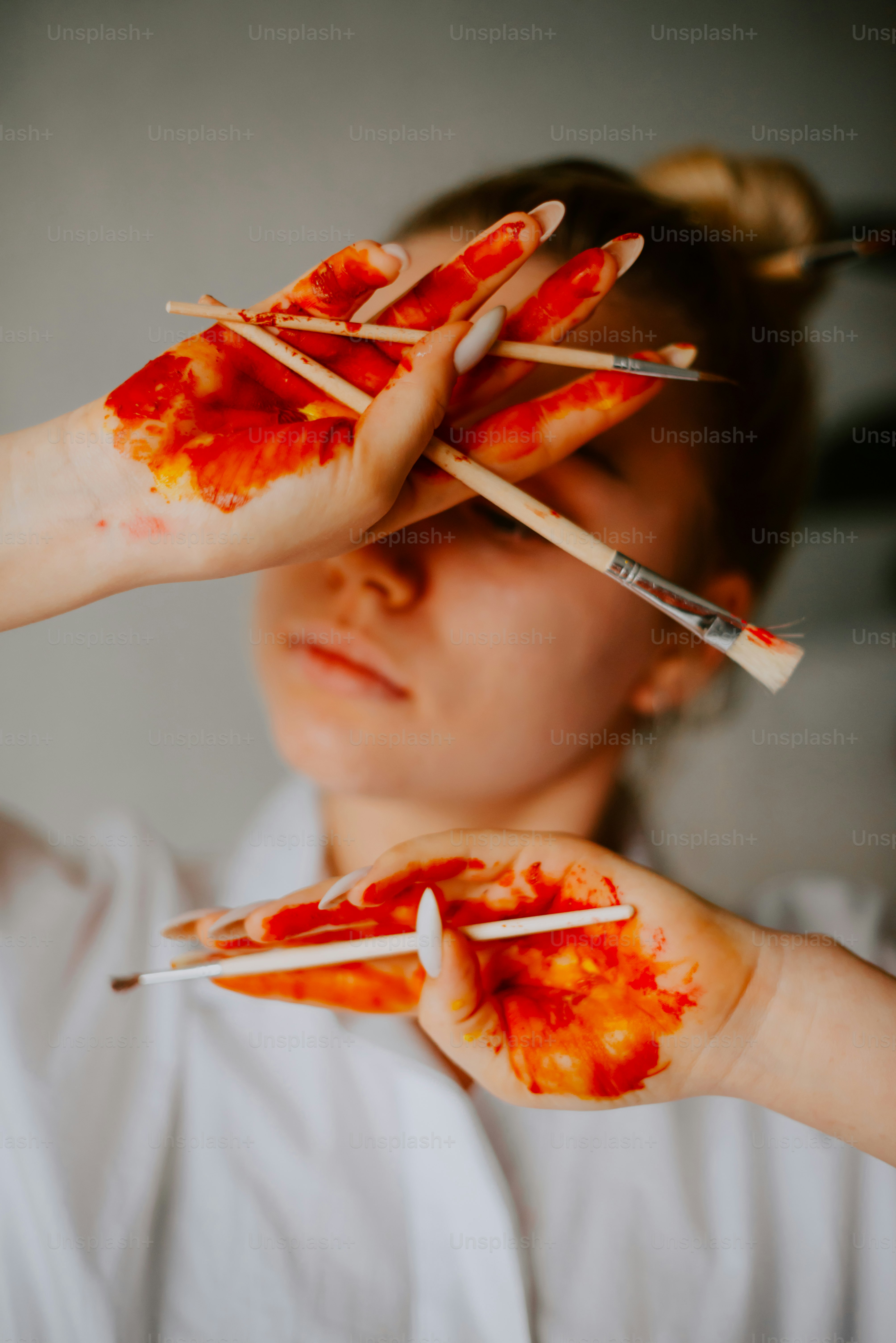 a girl with her hands painted with blood