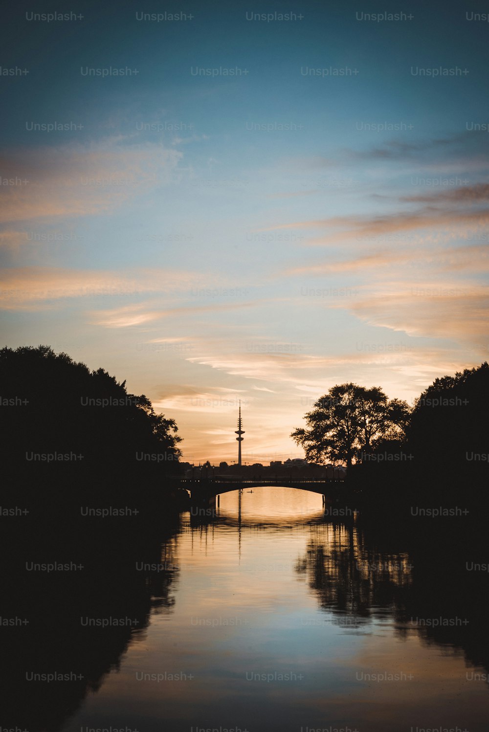 a body of water with a bridge in the background