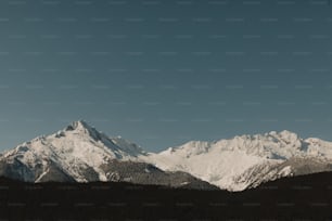 a view of a mountain range with snow on it