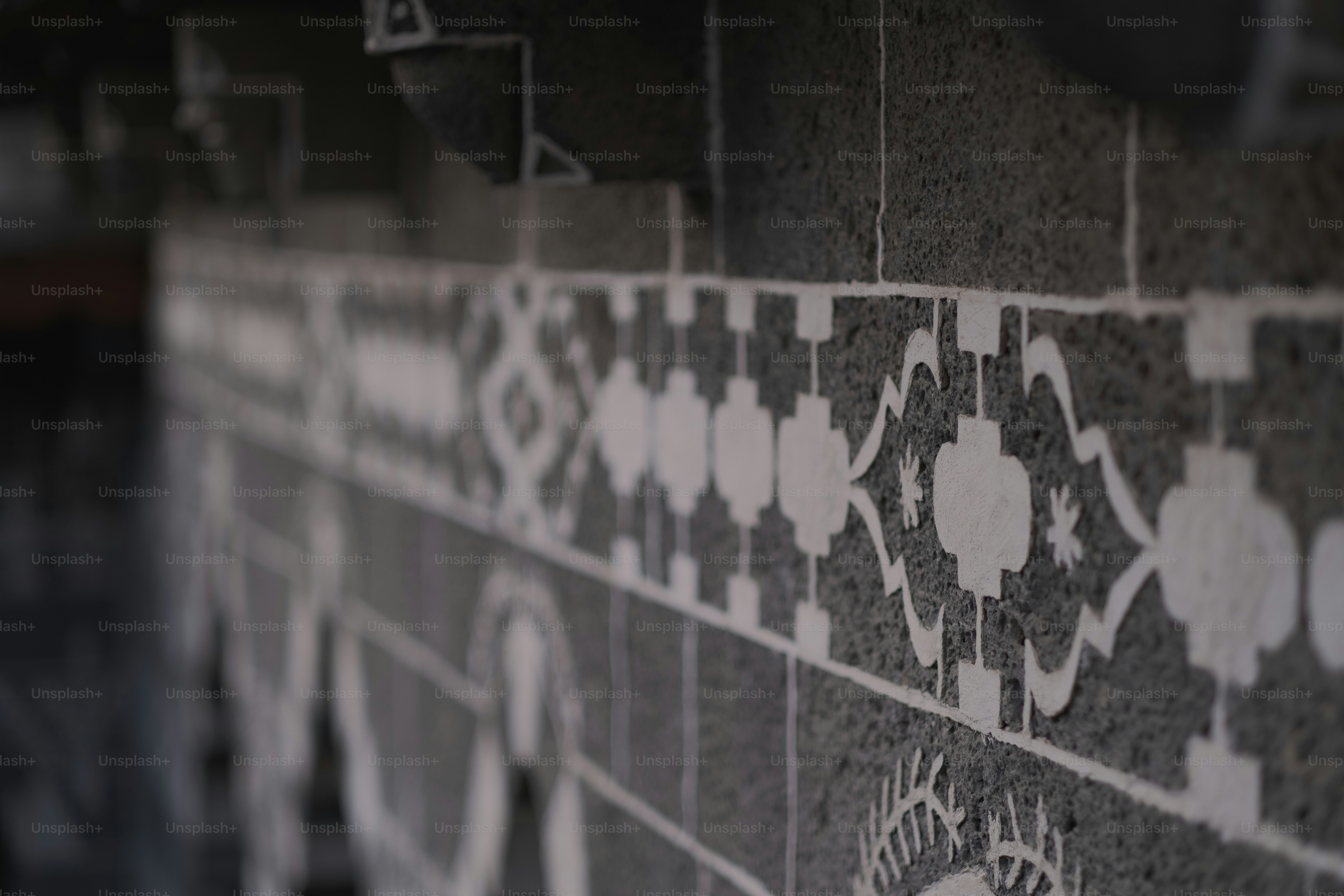 a close up of a wall with a tile design on it