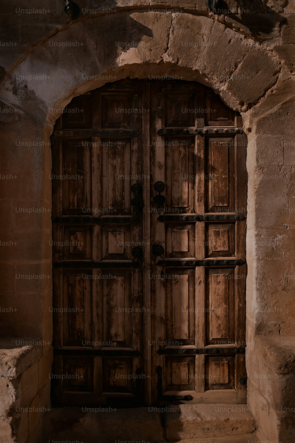 a wooden door in an old stone building