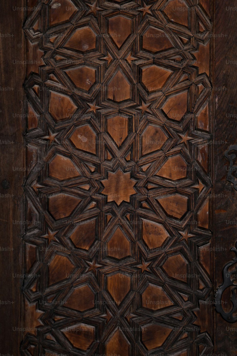 a close up of a wooden door with a decorative design