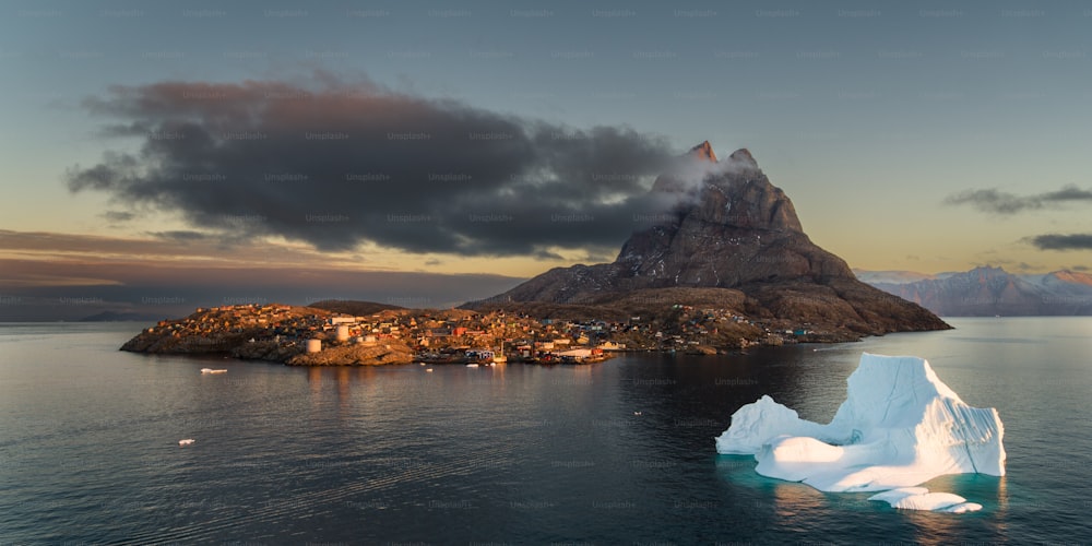 a large iceberg floating in the middle of a body of water