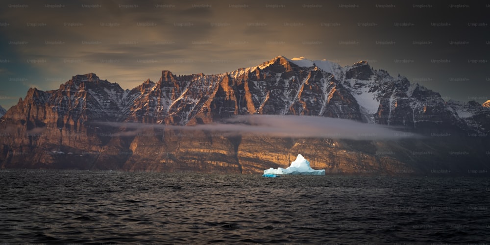 a large iceberg floating in the middle of a body of water