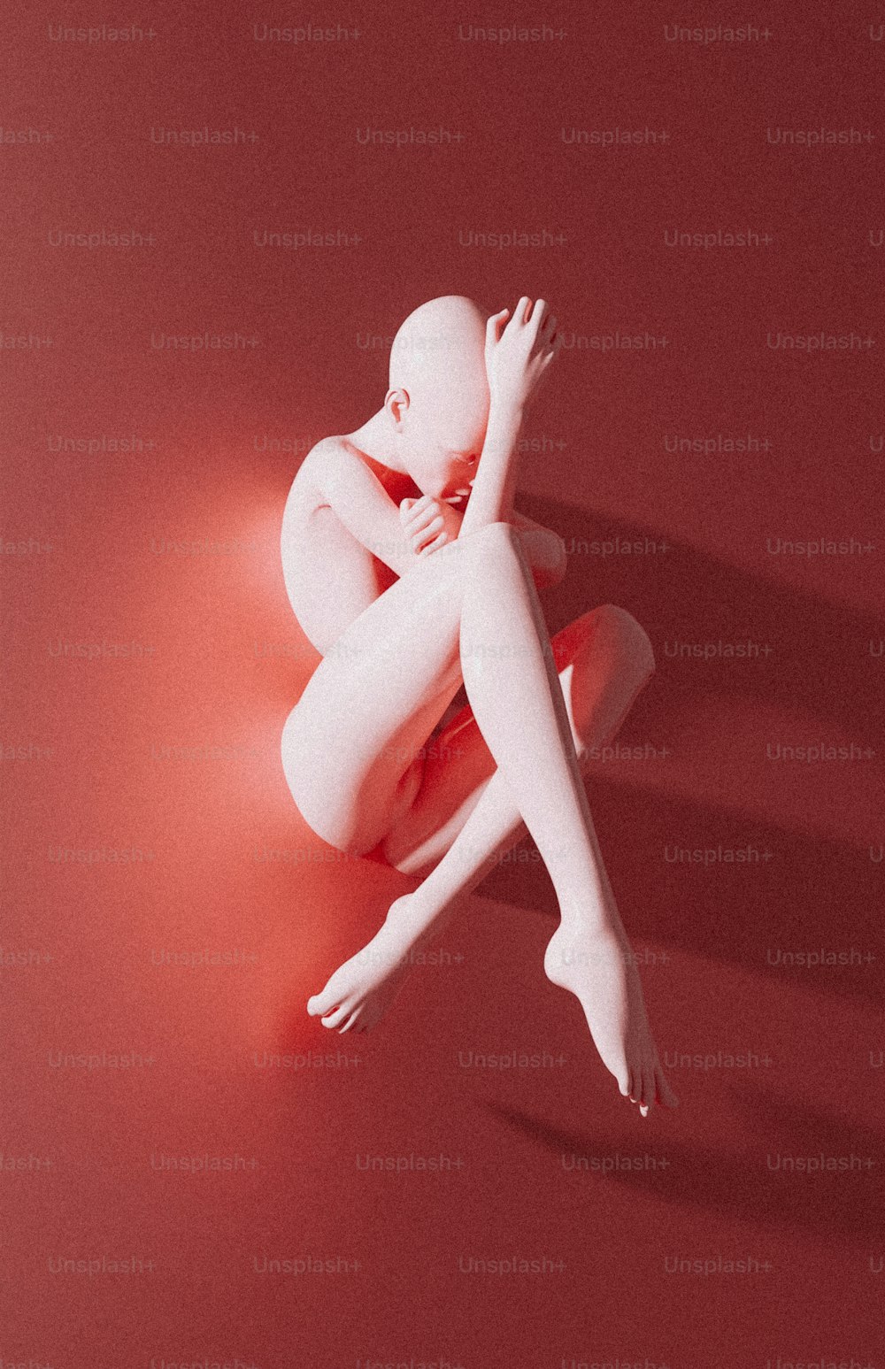 a white mannequin sitting on a red surface