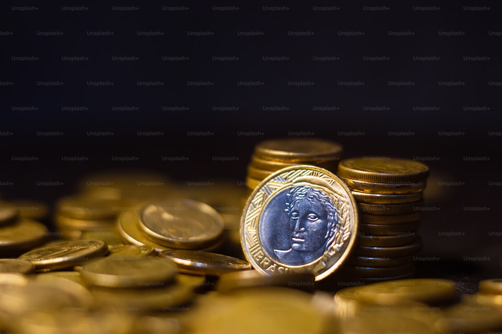 a pile of gold coins with a coin on top of it