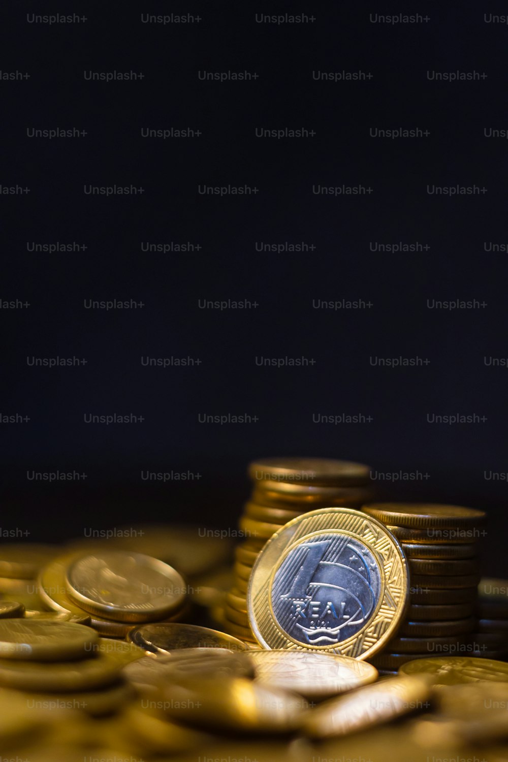 Una pila de monedas de oro con una azul en la parte superior