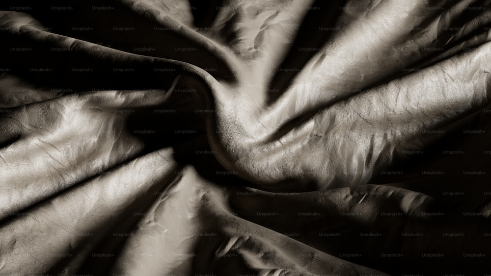 a black and white photo of a wrinkled fabric