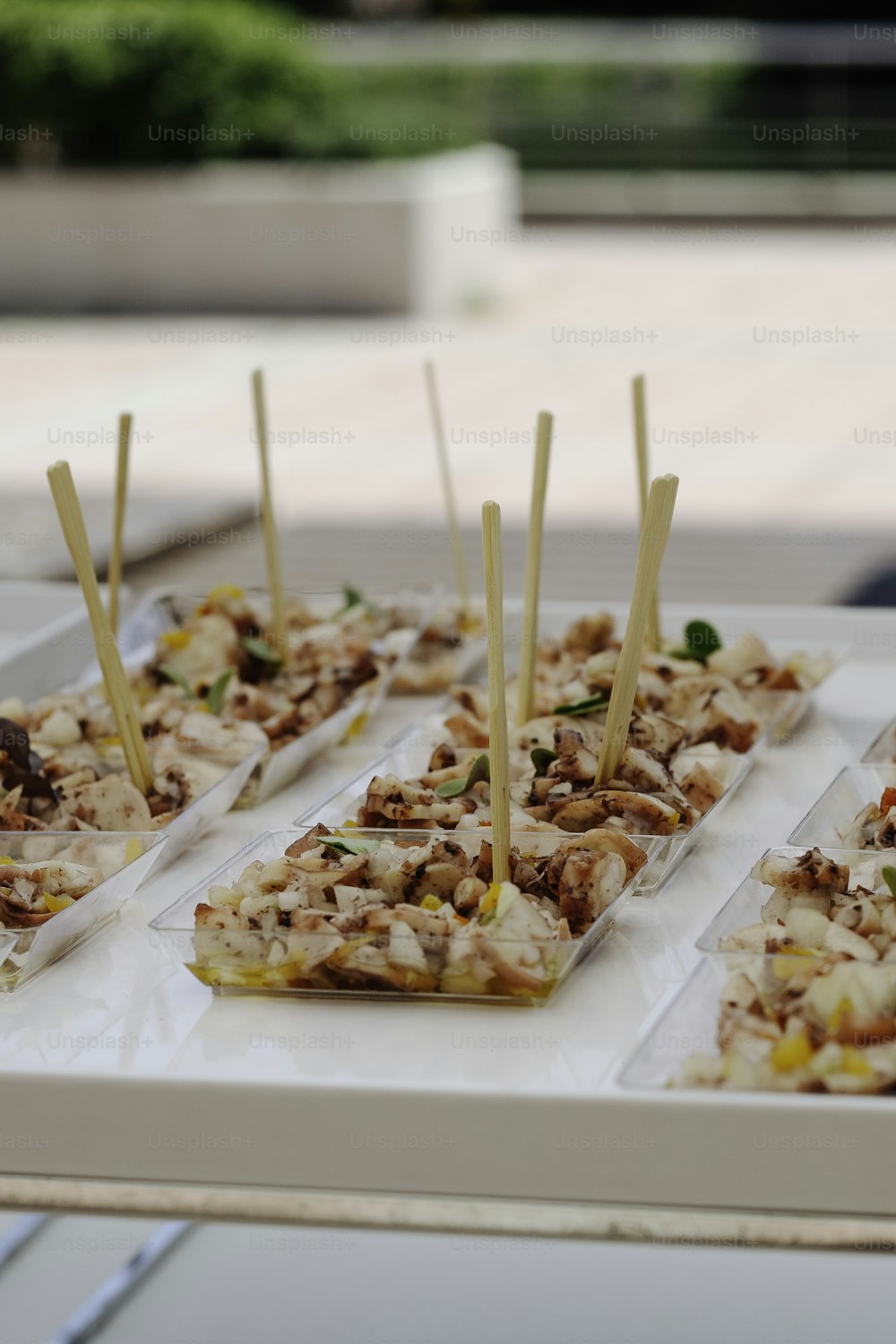 a table topped with trays of food covered in toppings