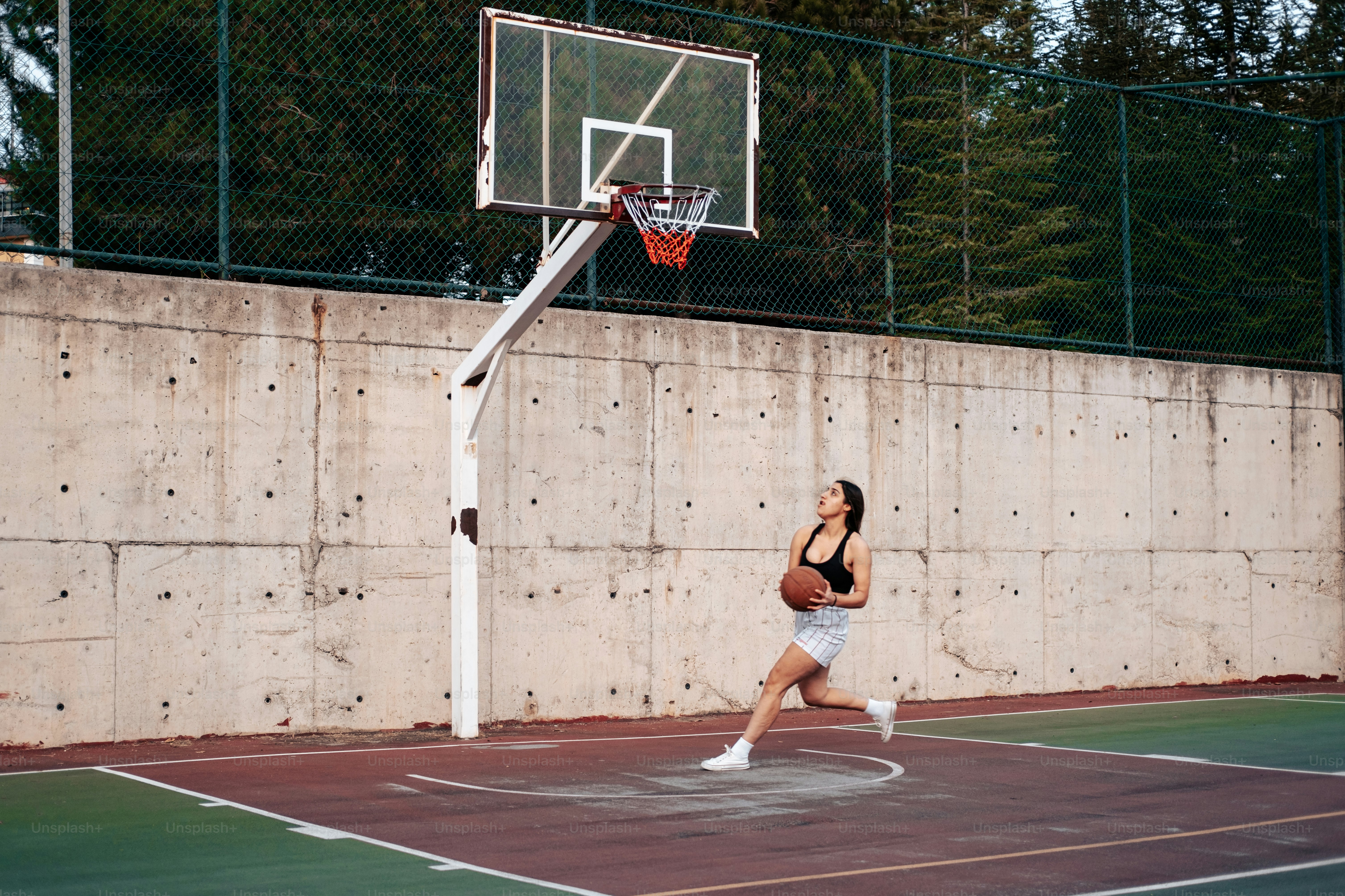 a woman is playing basketball on a court