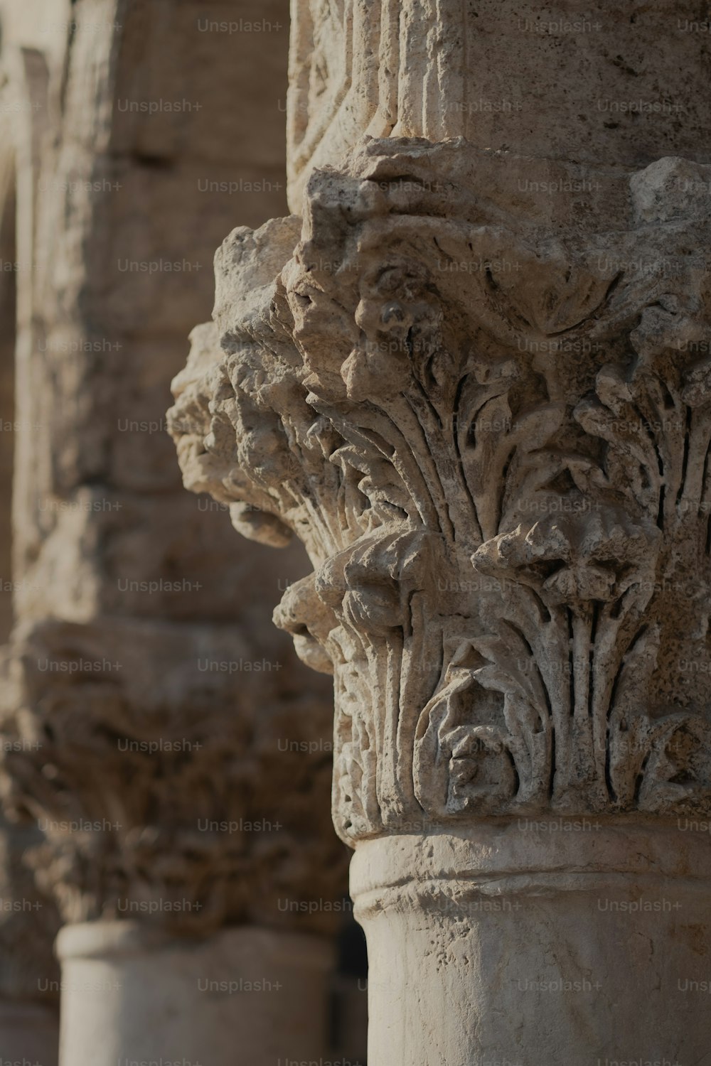 a close up of a column with a bird perched on top of it