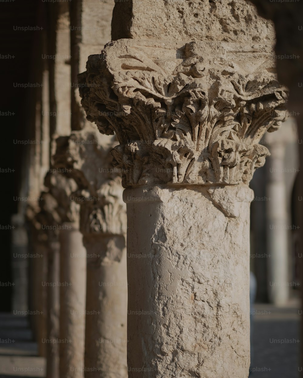 a close up of a stone column with carvings on it