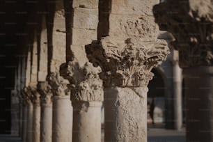 a row of stone pillars in a building