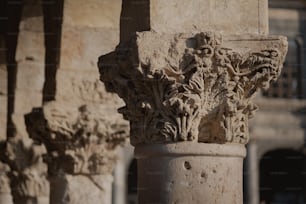 a close up of a column with a building in the background