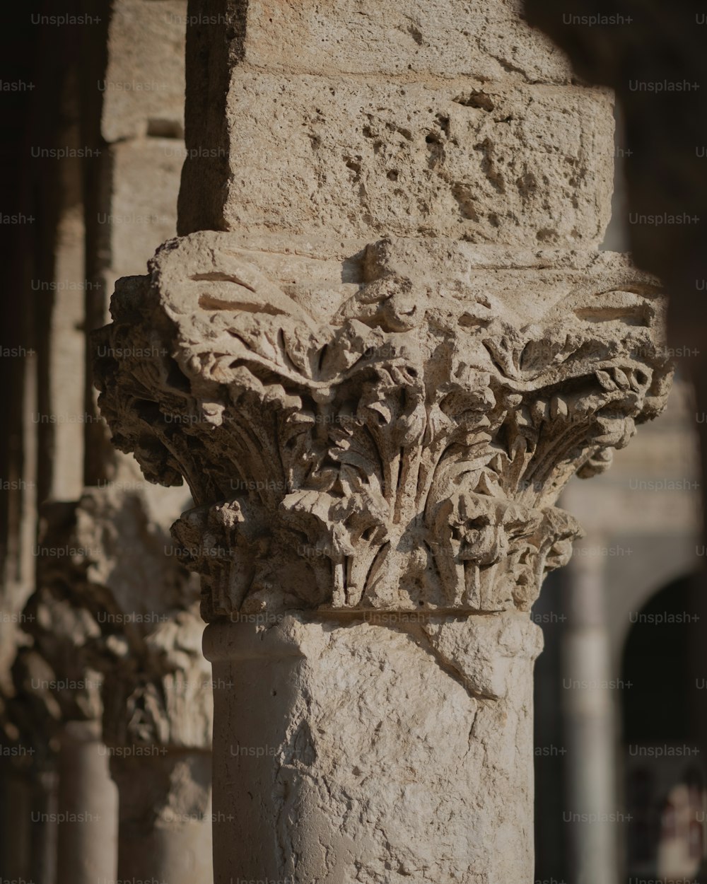 a close up of a stone column with carvings on it