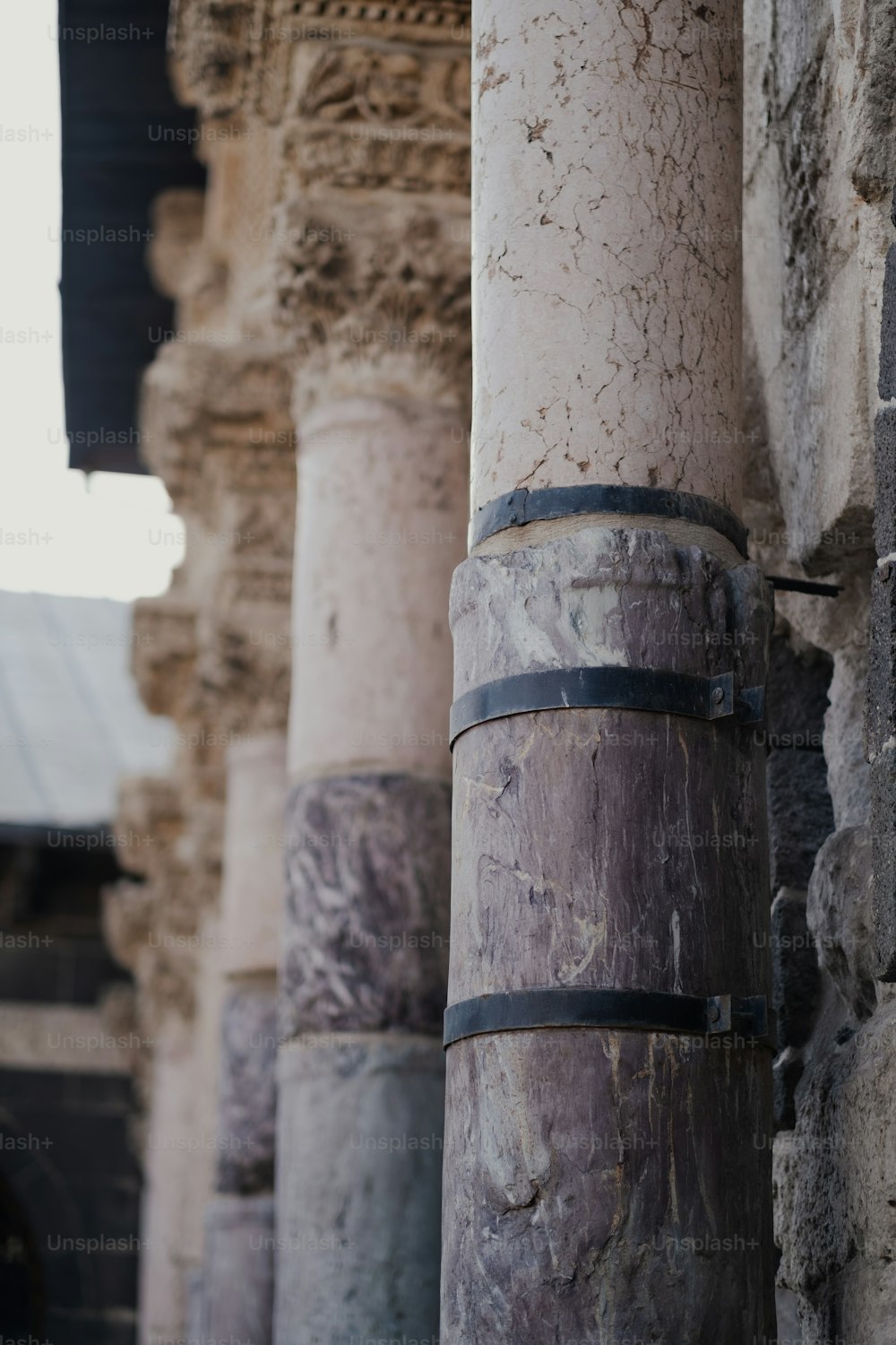 a close up of a column with a clock in the background