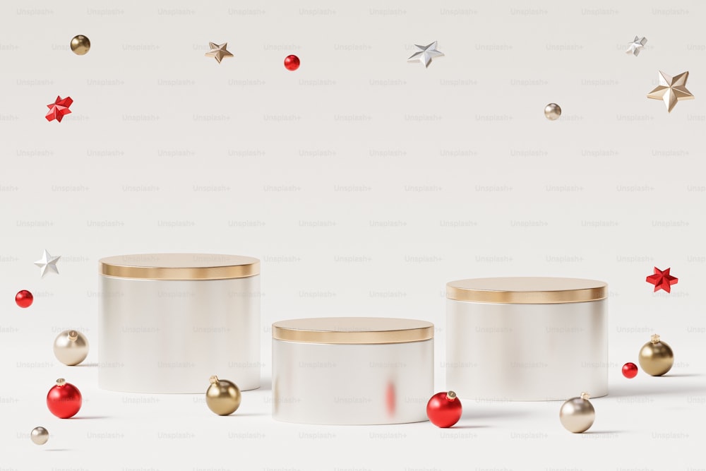 three white canisters with red and gold ornaments