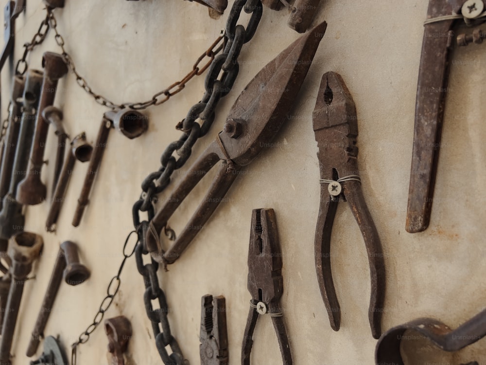 a bunch of tools are hanging on a wall