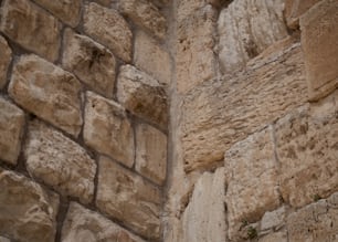 a close up of a stone wall with a clock on it